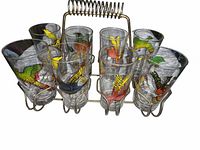 set of eight bird motif glasses in metal carrier