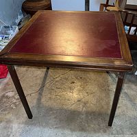 Full view of table showing burgundy vinyl top and wood frame