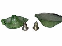 overall view of green glass reamer, green glass bowl, two metal shakers