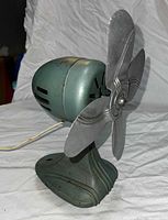 left side view showing base, housing, cord, blade hub
