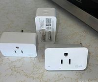 Three WYZE smart plugs showing front and side views