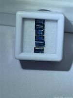 Row of blue sapphire baguettes in gem case