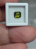 Front view of octagon-cut green tourmaline in display box