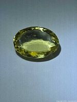 Front view of oval lemon citrine with facet pattern visible
