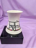 Side view of ceramic creamer showing abstract design