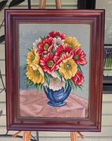Front view of framed needlepoint floral still life