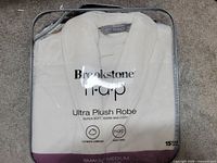 Front view of packaged robe showing brand, line and size
