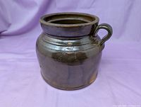 Front view of brown stoneware bean pot with single handle