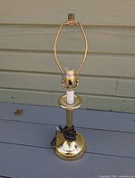 Full view of brass candlestick lamp without bulb lit