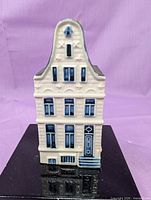 front view showing stepped gable facade and blue detailing