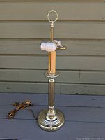 full view of brass lamp showing base, column, sockets, repaired cord