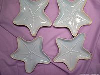 Top view of all four starfish plates showing color, shape and bead design