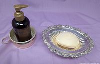 Round silver-plated dish with bottle for scale and oval footed dish with soap for scale