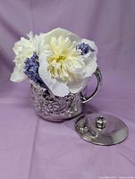 sugar bowl body filled with flowers, lid placed beside