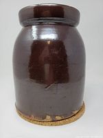 Front view of brown glazed stoneware crock