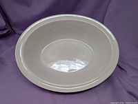 Top view of cream oval bowl showing interior surface and crazing