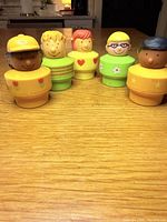 Front view of all five plastic toy figures standing upright