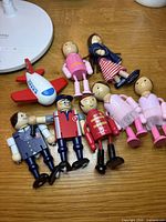 Group shot showing all figures and airplane on wood surface