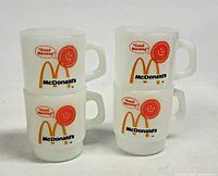 Four white milk glass McDonald's Good Morning mugs stacked in twos