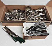 overview of three boxes of flatware and carving set