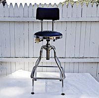 Front view of stool showing seat, backrest, chrome frame