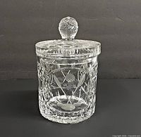 Front view of crystal jar showing golf club motif and lid
