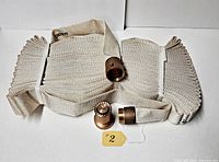 Coiled fire hose with coupling, nozzle and tag visible