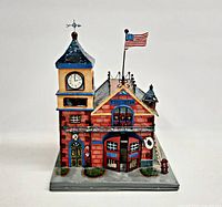 Front view showing clock tower, flag, doors, base