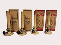 Four beige plastic window candles with cords and four original boxes