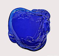 Top view of cobalt blue glass tray showing woman and harp relief