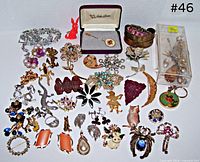 Overall view of brooches, earrings, boxed stick pin, bracelet, carded earrings and accessories