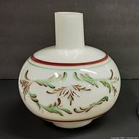 Front view showing painted foliate motif and cylindrical fitter