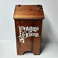 Front view of wooden bin with lid closed and stencilled lettering
