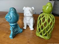 All three ceramic figurines grouped on table