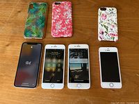 Front view: 3 cases above, 4 powered-on phones below