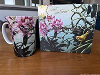 Mug and original box showing floral and bird artwork
