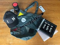 All items laid out: cap, tote, lanyard, mug, boxed car care set
