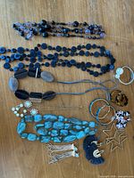 All jewelry pieces laid out on wood surface