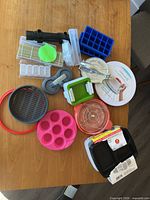 All items spread on table, showing variety of kitchen gadgets and containers