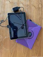 Front view of Samsung Galaxy Tab with charger cable and purple case
