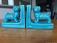 front view of both ceramic dog bookends showing color and design