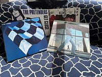 All four album covers displayed on sofa
