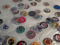Wide view of loose sleeved pogs and slammers spread on surface