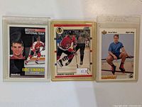 Front view of all three hockey cards in holders