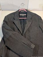 Front view of gray corduroy blazer showing lapel, button stance and sleeve