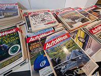 Stacked AutoWeek magazine issues spread across table