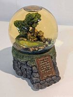Full view snow globe showing base and globe