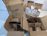 Boxes containing multiple glass tealight holders and LED candles