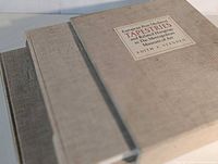 Two linen-bound volumes stacked, showing cloth texture and size