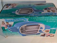 Retail box top showing Fun 2 Bake Oven image and branding, box damage visible